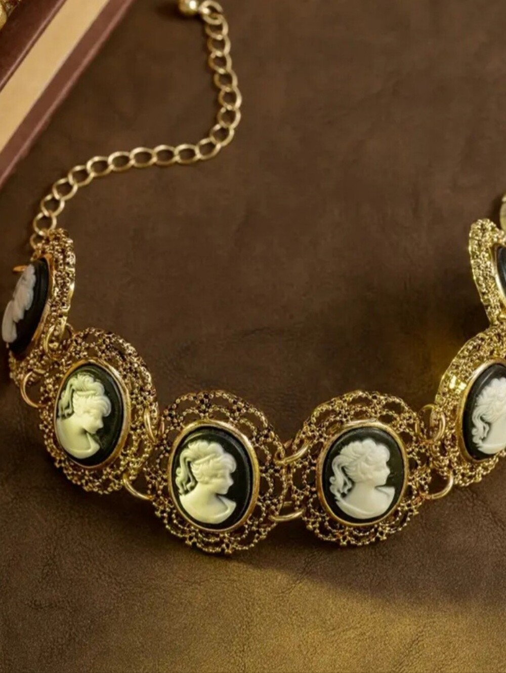 Cameos - Exquisite Gold Bracelet With Black Background White Cameos.